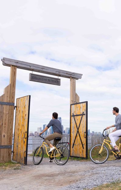 Two man riding bike into the gate