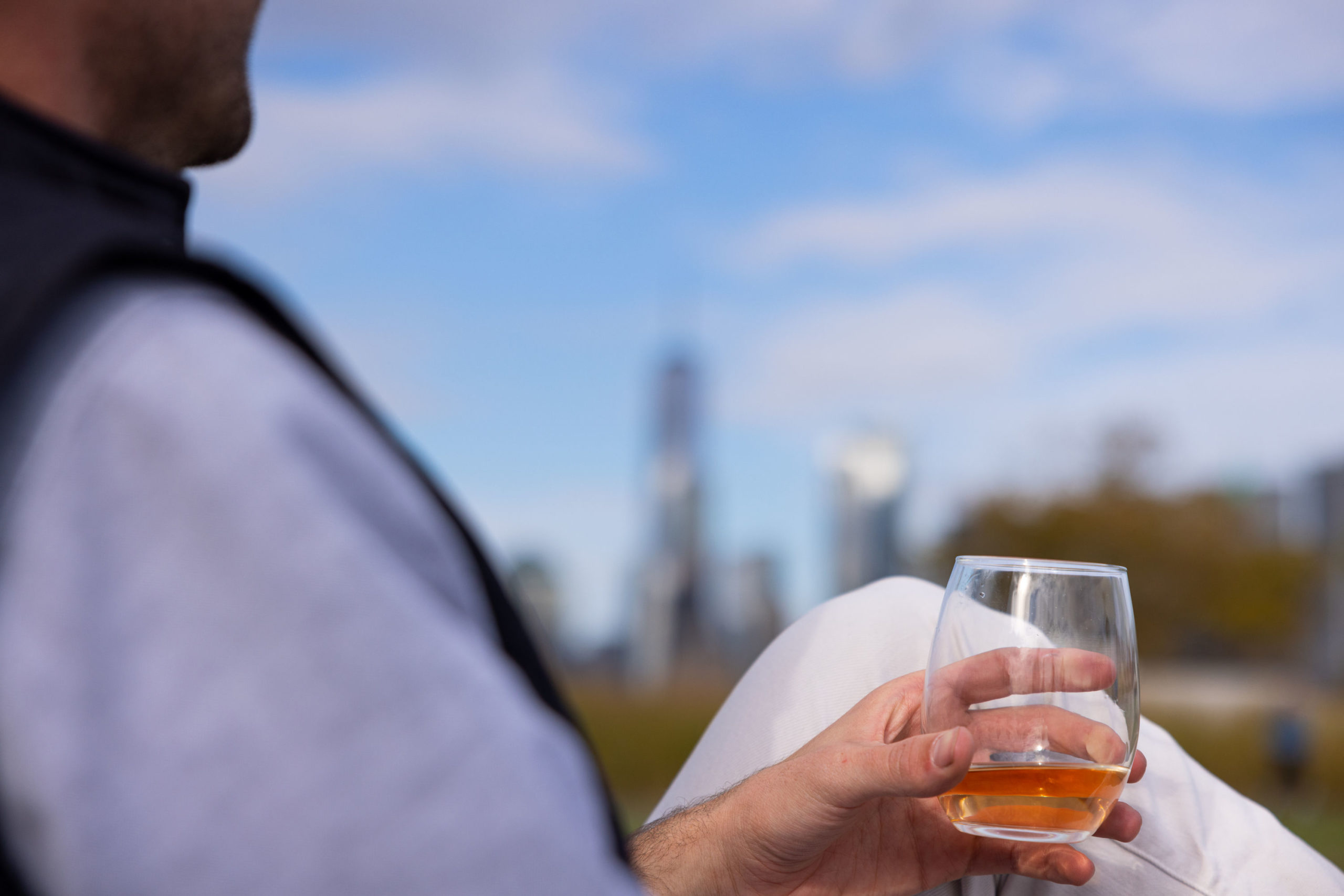 Man sitting outside and holding a glass of drink