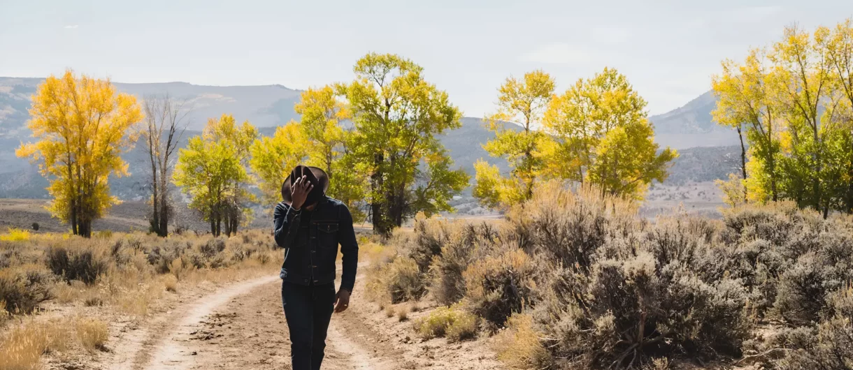 Man walking in desert valley in colorodo